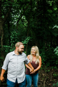 couple surrounded in greenery of the forest preserve
