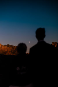 silhouette of bride and groom staring at the moon at Cathedral Rock in Sedona, Arizona