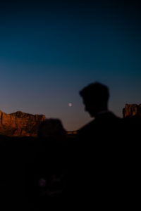 silhouette of bride and groom staring at the moon at Cathedral Rock in Sedona, Arizona