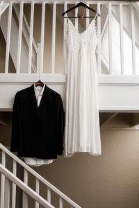 Dress and suit hanging in home while getting ready