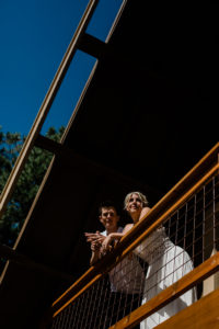 Christy and Dustin standing on the balcony of the Flagstaff, Arizona home before their elopement