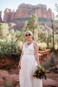 Christy in her dress standing at the base of Cathedral Rock in Sedona Arizona